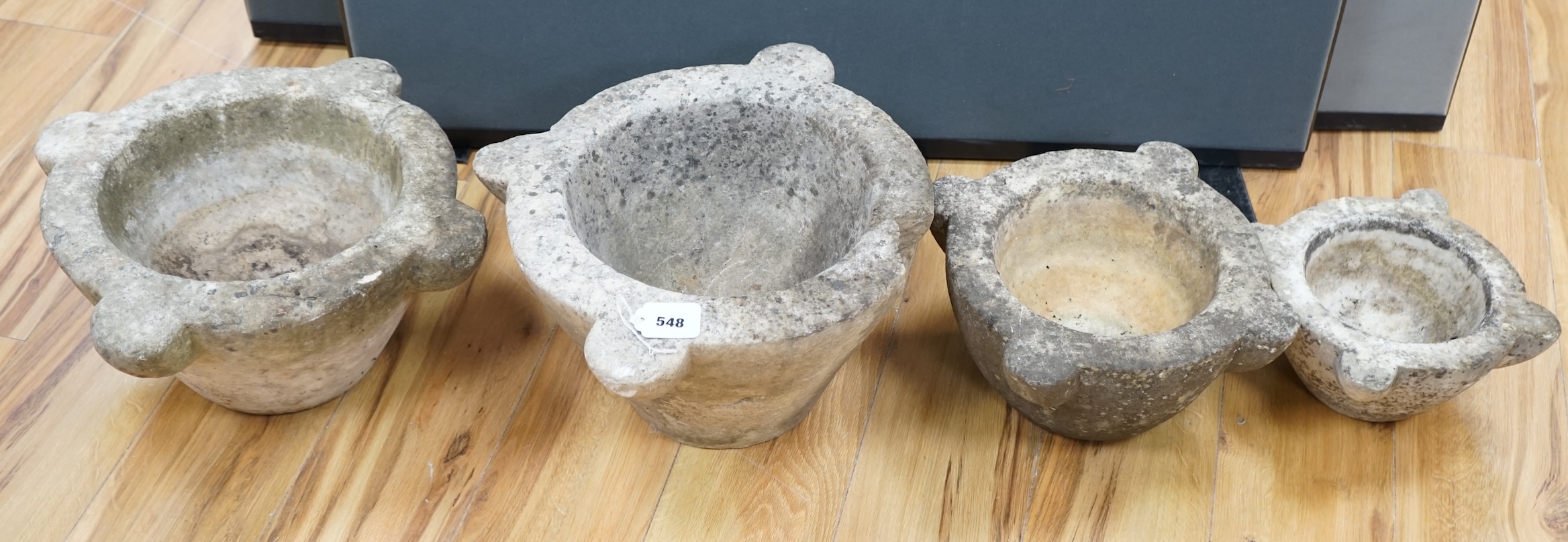 Four graduated marble mortars, largest 46.5cm wide across top rim. Condition - largest mortar has a handle missing, all have been stored outside and are marked